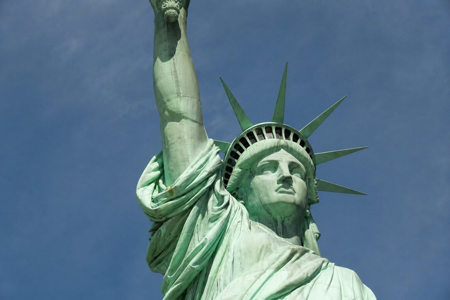 Close-up view of the Statue of Liberty against a clear blue sky