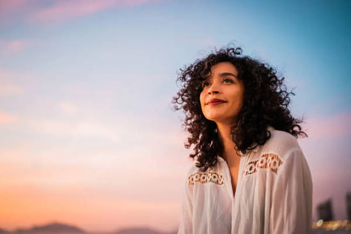 Woman looking ahead outdoors at dusk